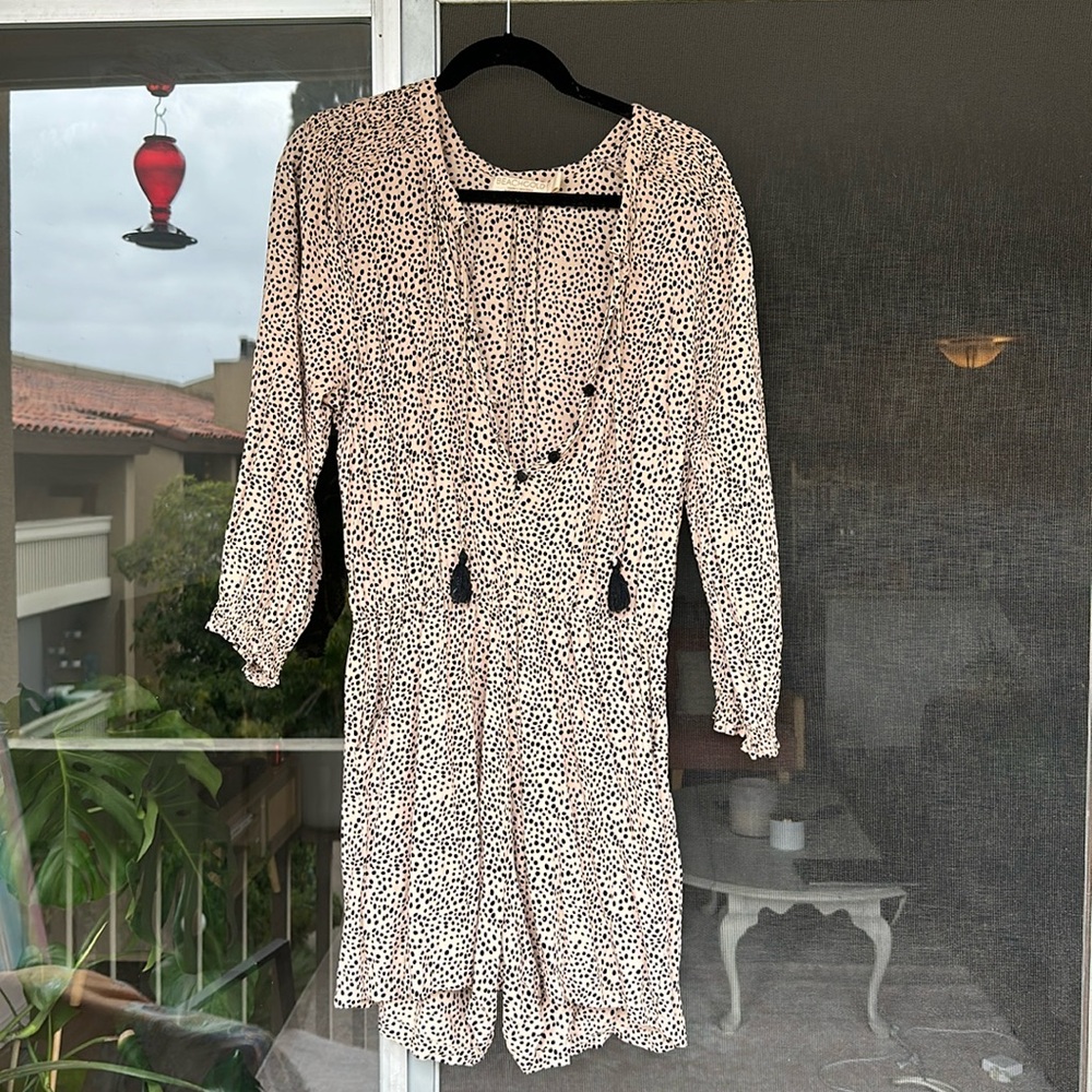 Beachgold polka dot romper with button up detail and tassels.